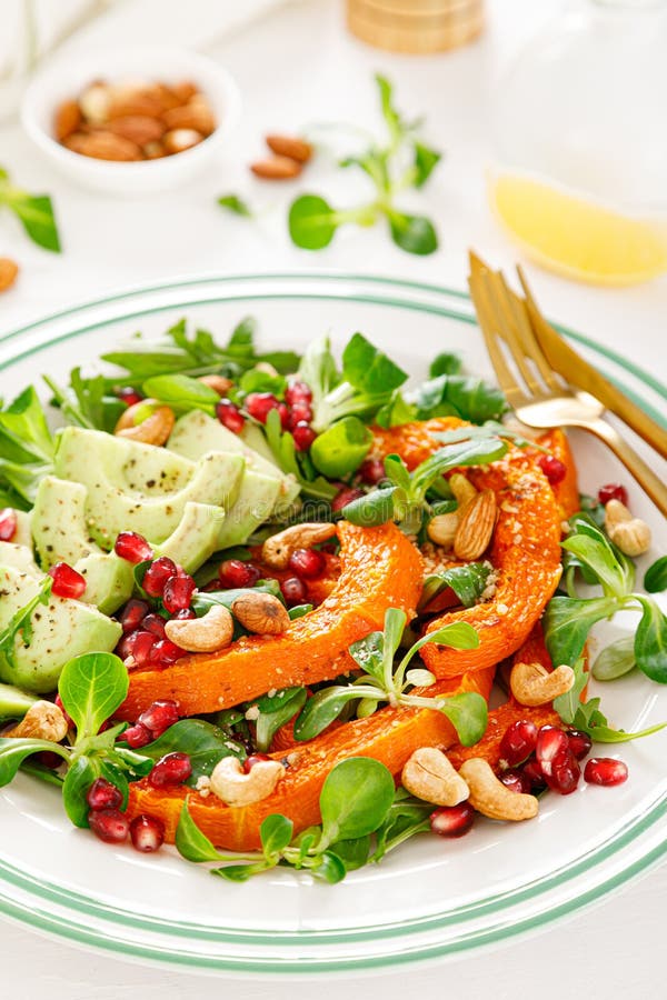 Fresh vegetable salad with lambs lettuce, baked butternut squash or pumpkin, avocado, pomegranate, cashew and almond nuts. Healthy