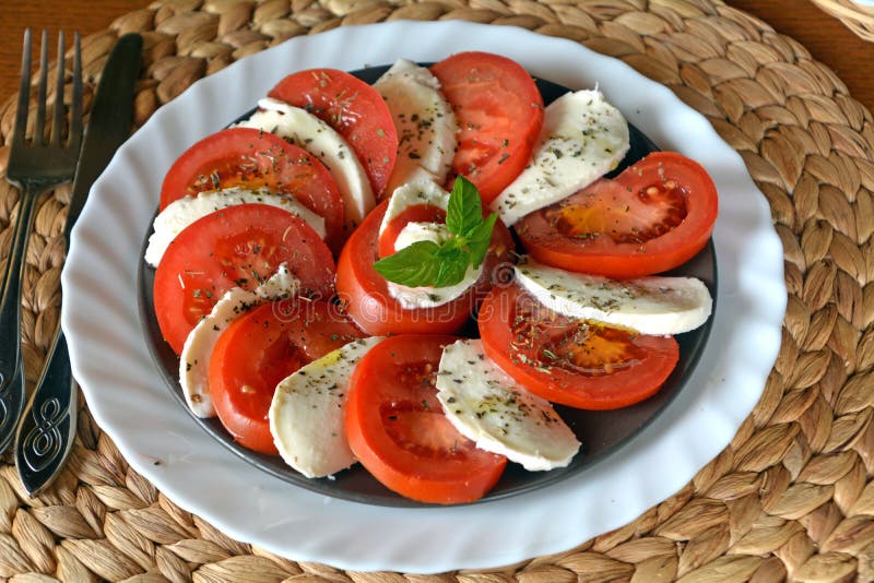 Fresh vegetable salad with mozzarella, tomato and basil