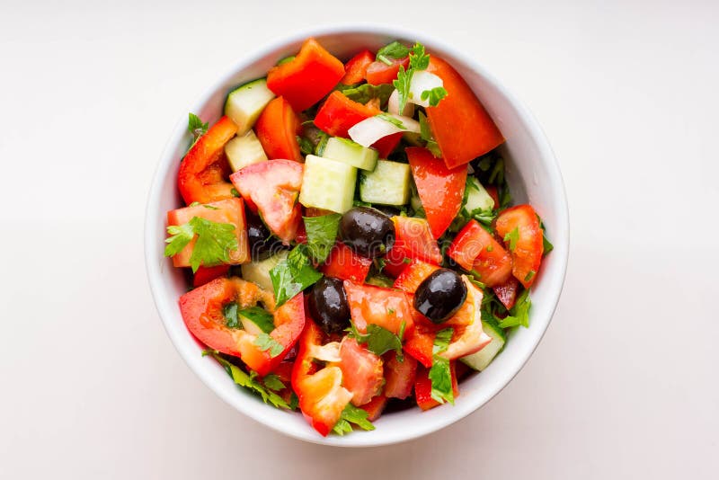 Fresh vegetable salad in white bowl isolated on white