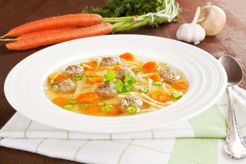 Fresh vegetable soup. Vegetable soup in white plate with fresh vegetable in background. Rustic style healthy eating concept royalty free stock images Fresh vegetable soup. Vegetable soup in white plate with fresh vegetable in background. Rustic style healthy eating concept royalty free stock images