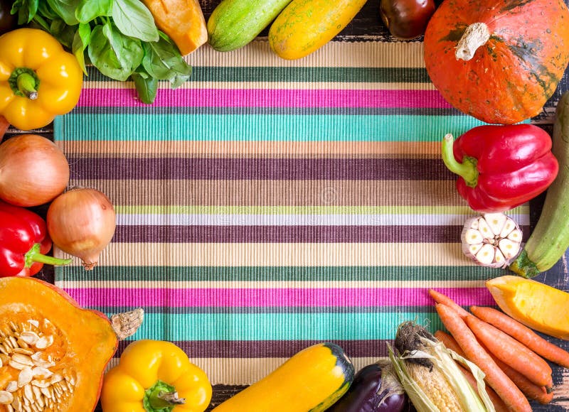 Fresh vegetables on a colorful striped kitchen towel. Autumn background