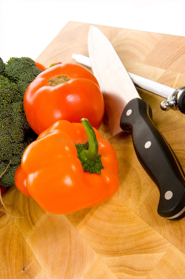 Fresh vegetables on cutting board with knife