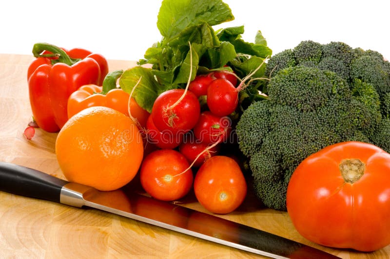 Fresh vegetables on cutting board with knife