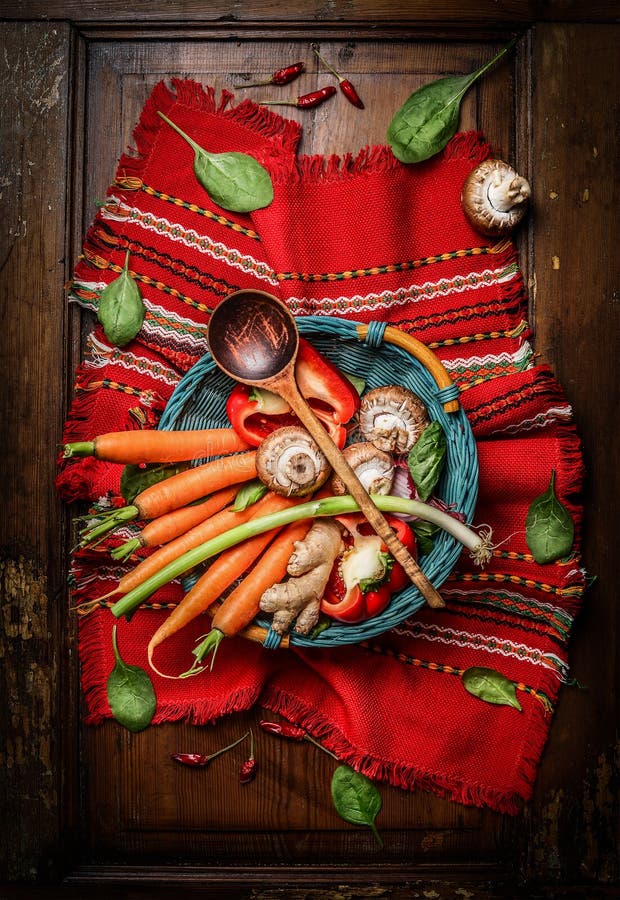 Fresh vegetables ingredients in basket with cooking spoon on rustic napkin. Vegetarian and healthy food concept. stock image Fresh vegetables ingredients in basket with cooking spoon on rustic napkin. Vegetarian and healthy food concept. stock image