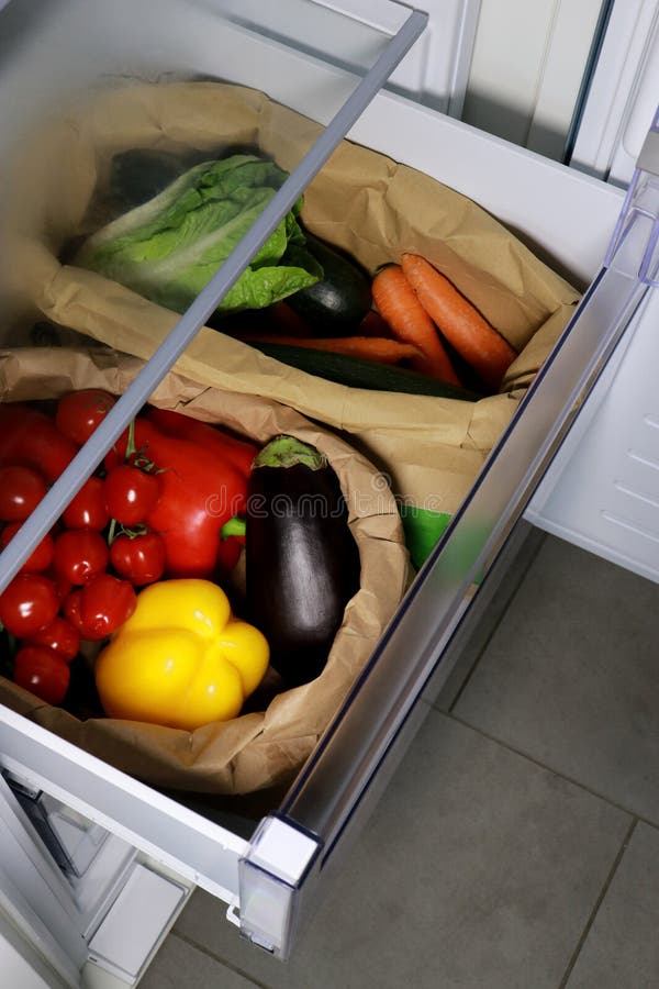 Fresh vegetables in open fridge in a kitchen, close up upper view stock photos