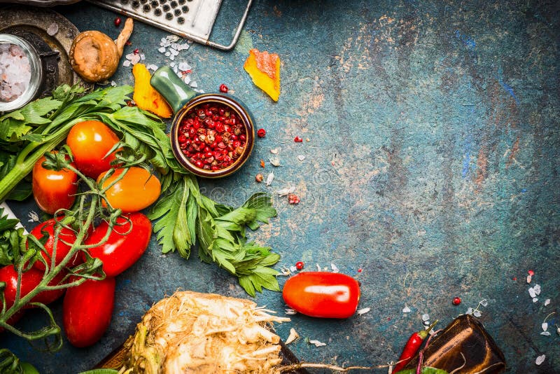Fresh vegetables and spices ingredients for tasty vegetarian cooking on dark rustic background. Top view royalty free stock images