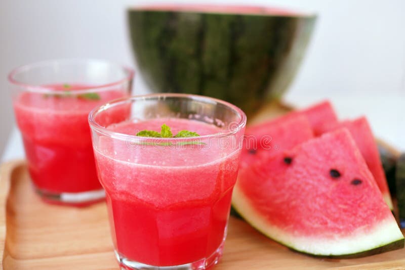 Fresh Watermelon Juice is in a Glass and Sliced Watermelon on the Plate