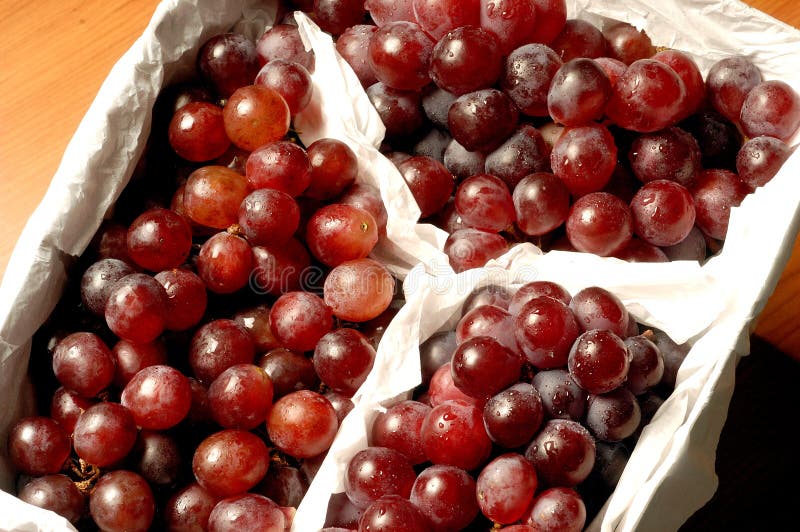 Fresh White Seedless Grapes on the Vine in a Wooden Crate O Stock Photo