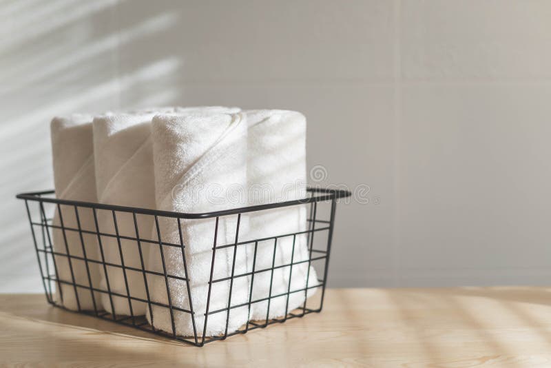 https://thumbs.dreamstime.com/b/fresh-white-towels-rolled-fluffy-fabric-spa-textile-stack-metallic-basket-wooden-sunny-tabletop-fresh-white-towels-rolled-263770796.jpg