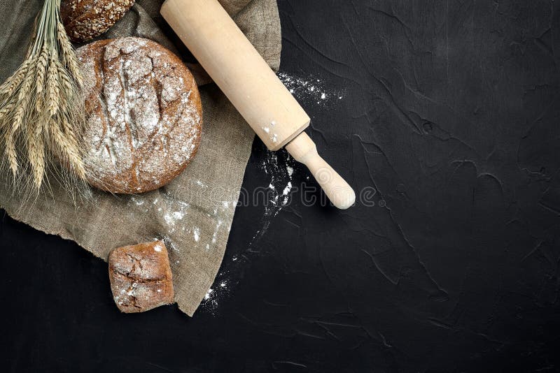 Freshly baked bread on dark kitchen table, top view