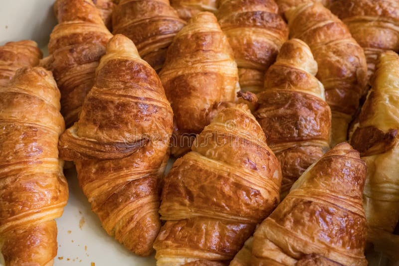 Freshly baked croissants closeup. Low depth of field bakery background