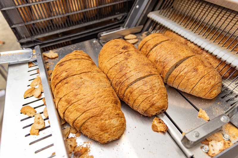 https://thumbs.dreamstime.com/b/freshly-baked-loaves-bread-bakery-sliced-sale-industrial-food-production-300421987.jpg