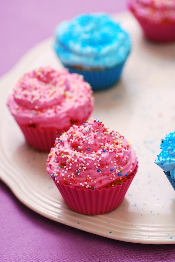 Freshly baked pink and blue cupcakes
