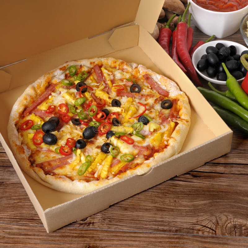 Freshly Baked Pizza in Delivery Box with Ingredients Stock Image