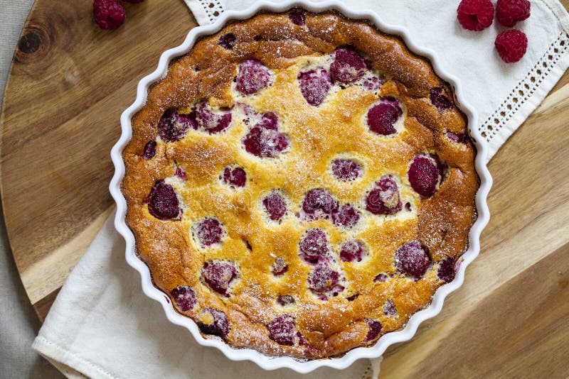 Freshly baked raspberry clafoutis stock photography