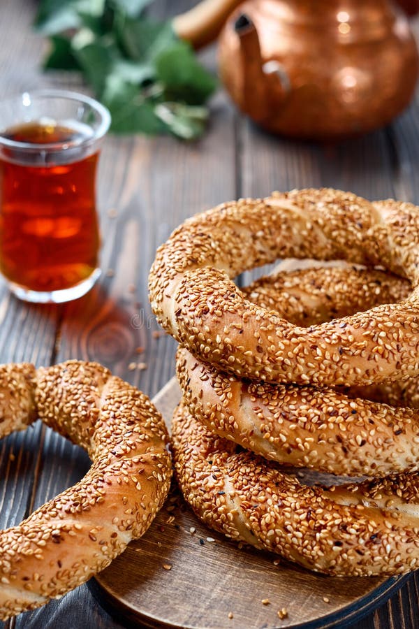 Freshly baked simit baked goods with sesame seeds close-up Turkish bagel - Gevrek or Kuluri. Traditional white bread with sesame