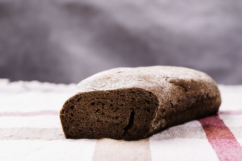 Freshly baked sliced rye bread on linen napkin. Freshly baked sliced rye bread on rustic tablecloth. Danish bread. Selective focus