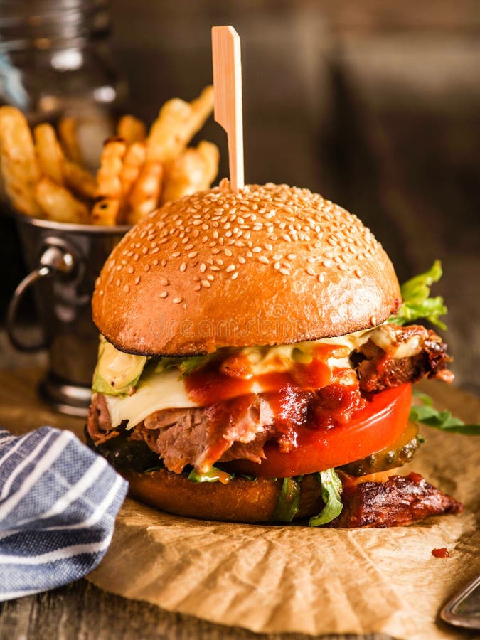 Burger With Beef And Fresh Herbs On A Dark Table. Rustic Soul St Stock