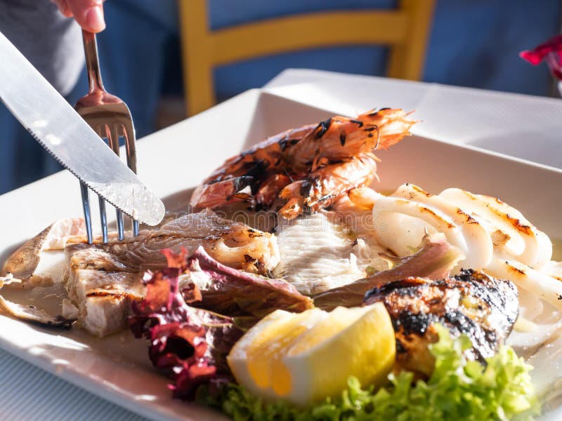 Freshly Grilled Italian Fish Dish on the Restaurant Table Stock Image