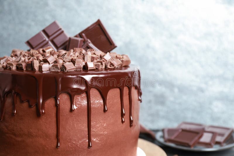 Freshly made delicious chocolate cake against background, closeup. Space for text