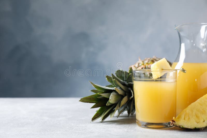 Freshly Made Pineapple Juice on Light Table. Space for Text Stock Image