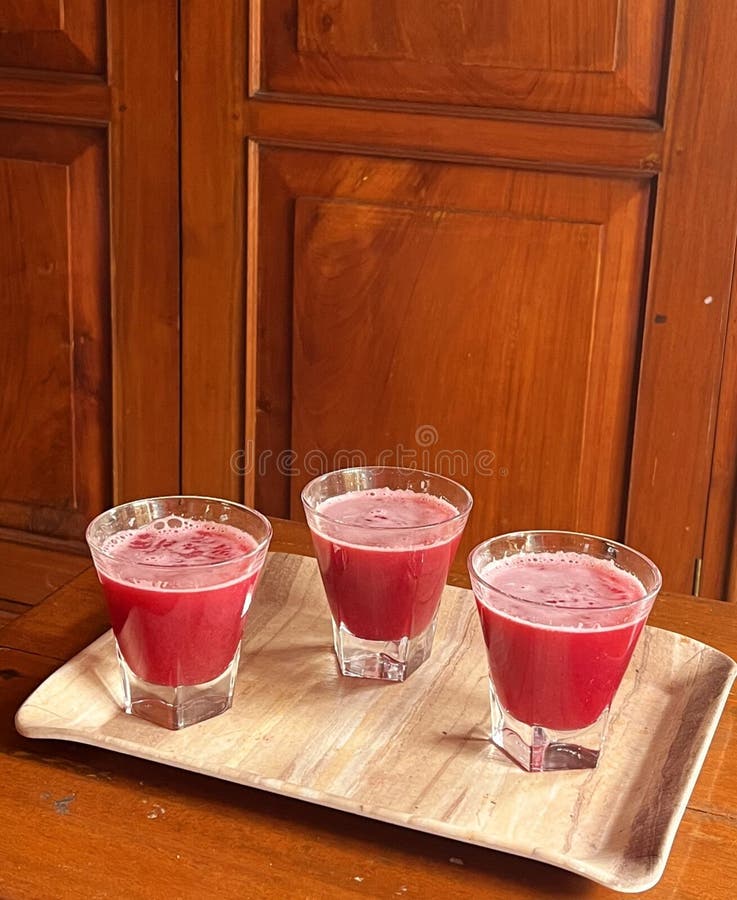 Freshly made pomegranate juice in cute glasses royalty free stock photo