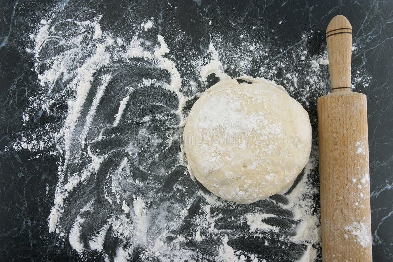 Freshly Prepared Dough on a Wooden Board. Rolling Pin and Flour Stock