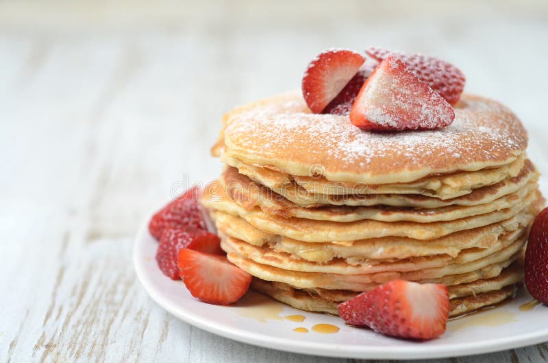 Freshly prepared pancakes with strawberries