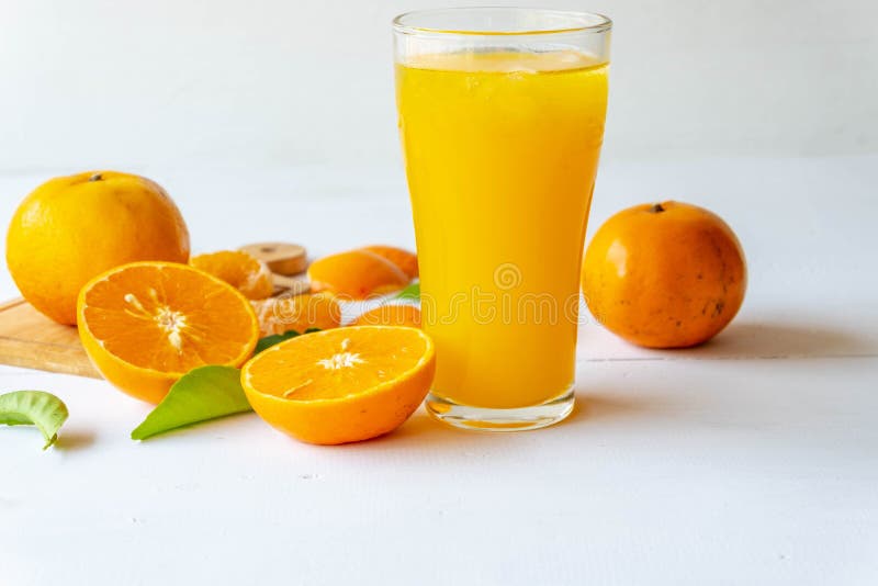.Freshly Squeezed Orange Juice in a Glass and Fresh Citrus Fruits on a