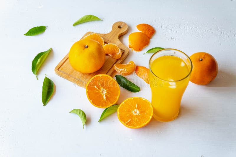 .Freshly Squeezed Orange Juice in a Glass and Fresh Citrus Fruits on a