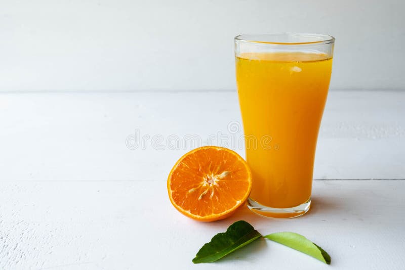 .Freshly Squeezed Orange Juice in a Glass and Fresh Citrus Fruits on a