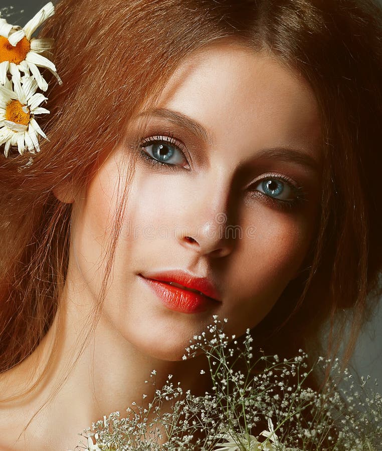 Freshness. Portrait of Romantic Redhead Woman with Chamomile