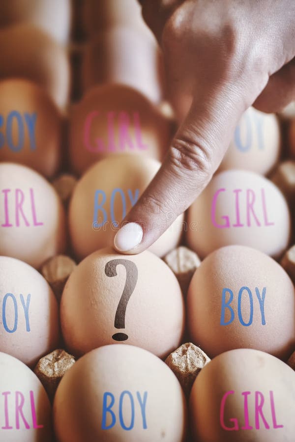 Female hand points to egg. Woman pointing to Question mark. Choose baby gender. Choosing the sex of child. Gender selection or Sex selection concepts. Female hand points to egg. Woman pointing to Question mark. Choose baby gender. Choosing the sex of child. Gender selection or Sex selection concepts