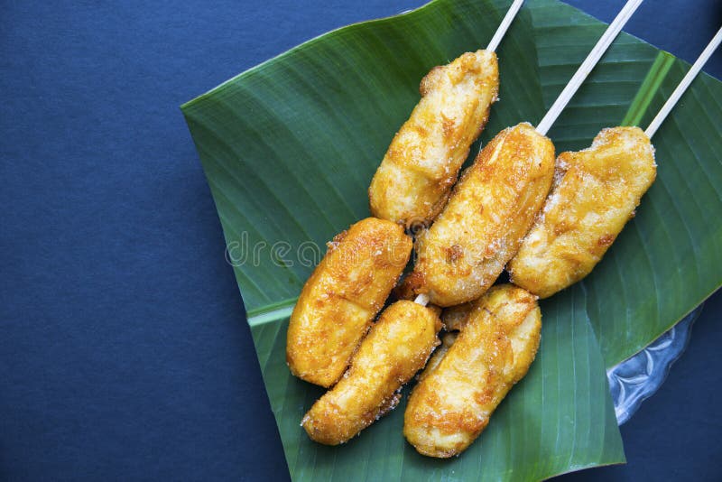 Fried banana cue on banana leaf plate. Sweet fruit cooked dessert.