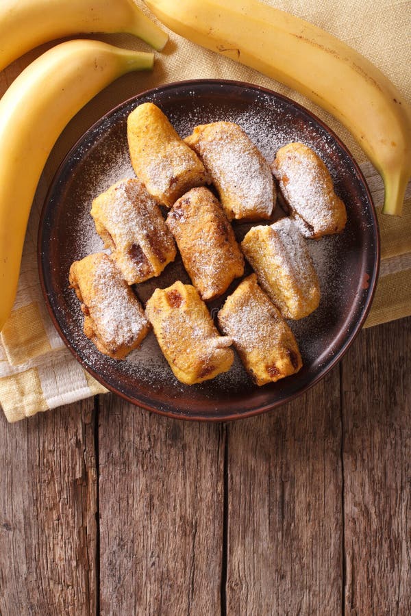 Fried Bananas in Batter on a Plate. Vertical Top View Stock Image