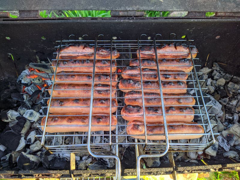 Fried Bbq Sausages on the Grill Under Hot Coals Top View Stock Photo