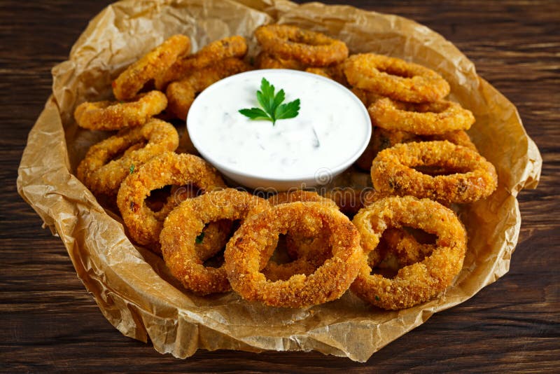Fried Breaded Onion Rings with Sauce on Baked Pepper Stock Image