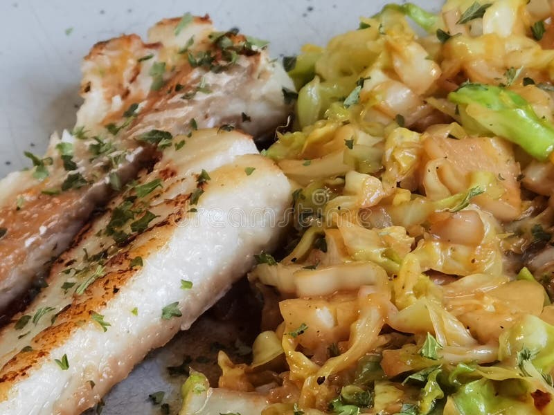 Fried cabbage with fish stock photo. Image of salad 224478472