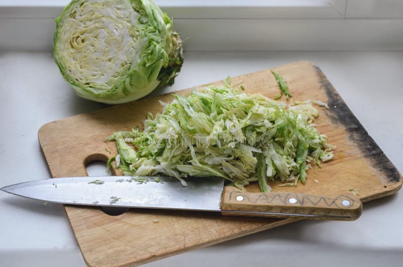 Fried white cabbage on a wooden board, half a head