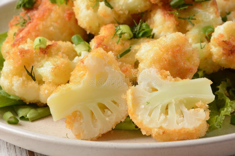 Fried Cauliflower Florets in Batter on a White Plate. Stock Image