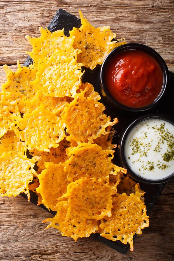Fried Cheddar Cheese Chips with Herbs Served with Sauces Closeup
