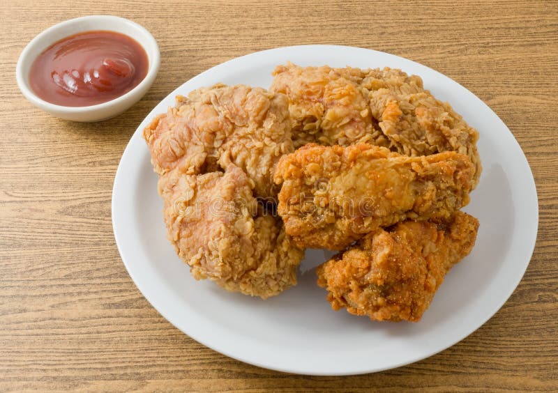 Cuisine and Food, Plate of Crispy Fried Chicken Served with Tomato Sauce on A Wooden Table. Cuisine and Food, Plate of Crispy Fried Chicken Served with Tomato Sauce on A Wooden Table.