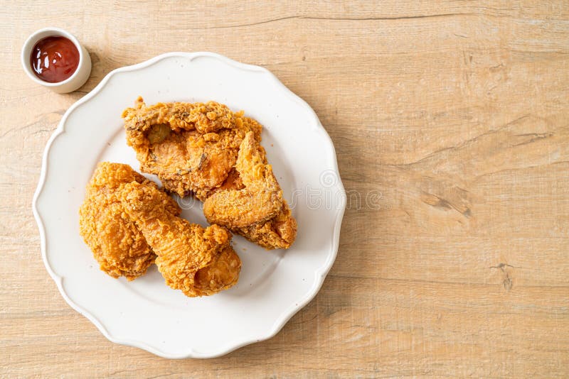 Fried chicken with ketchup on plate royalty free stock image