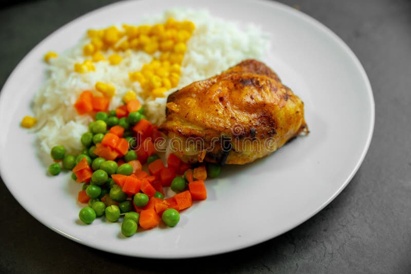Fried Chicken Leg with Rice, Corn, Carrots and Peas Stock Photo - Image