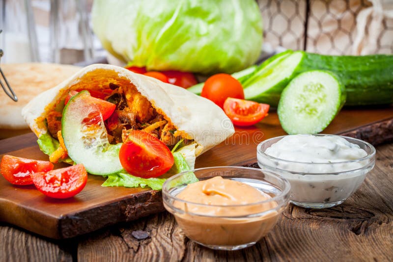 Fried chicken meat with vegetables in pita bread