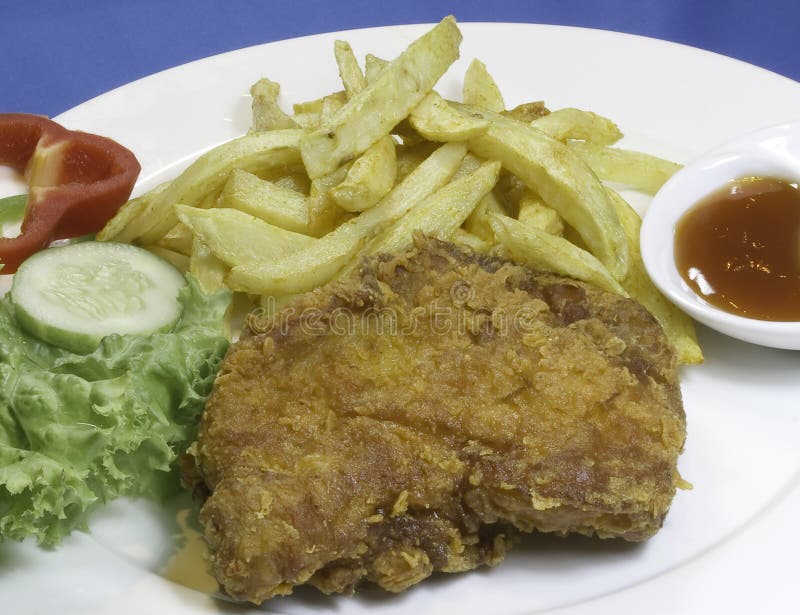 Fried chicken with potato fries and vegetables
