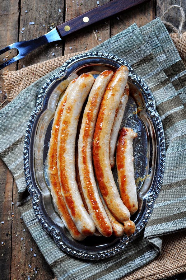 Fried Chicken Sausage on an Iron Plate, Rustic Style. Stock Image