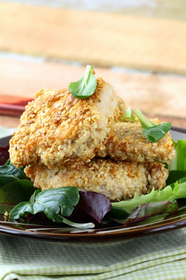 Fried chicken in sesame seeds stock photo