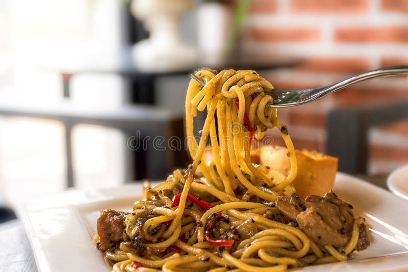 Fried Chicken Spaghetti with Black Pepper on White Plate with Fork and