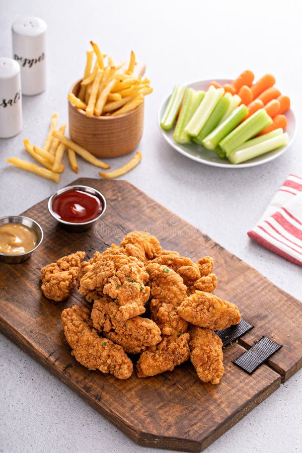 Fried Chicken Tenders or Strips with Sauces and Fries Stock Photo